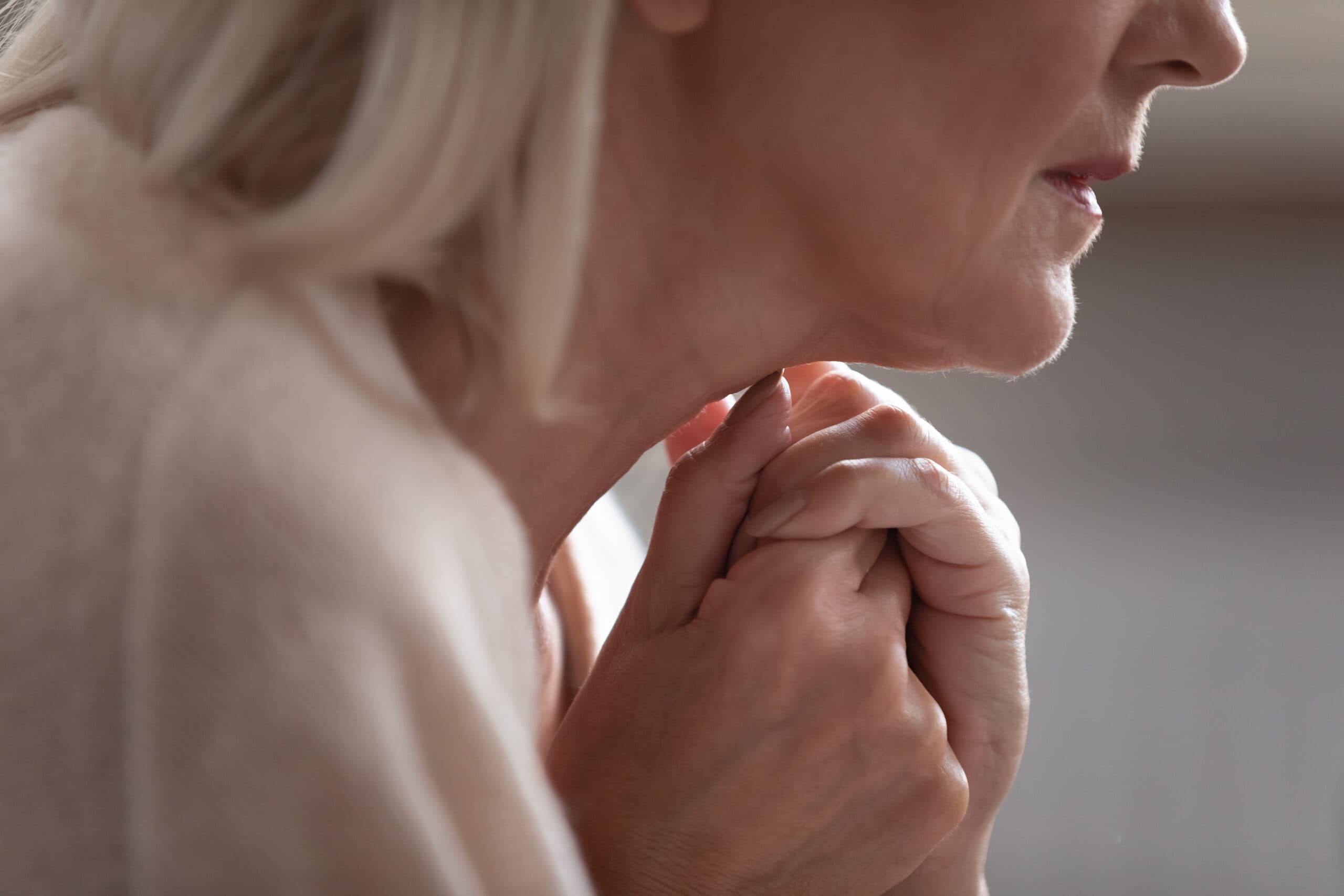 Close,up,side,view,older,worrying,retired,woman,joined,hands